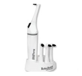 Electric toothbrush beside a manual toothbrush