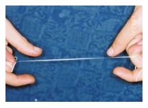 Flossing technique — floss hugging the side of the tooth